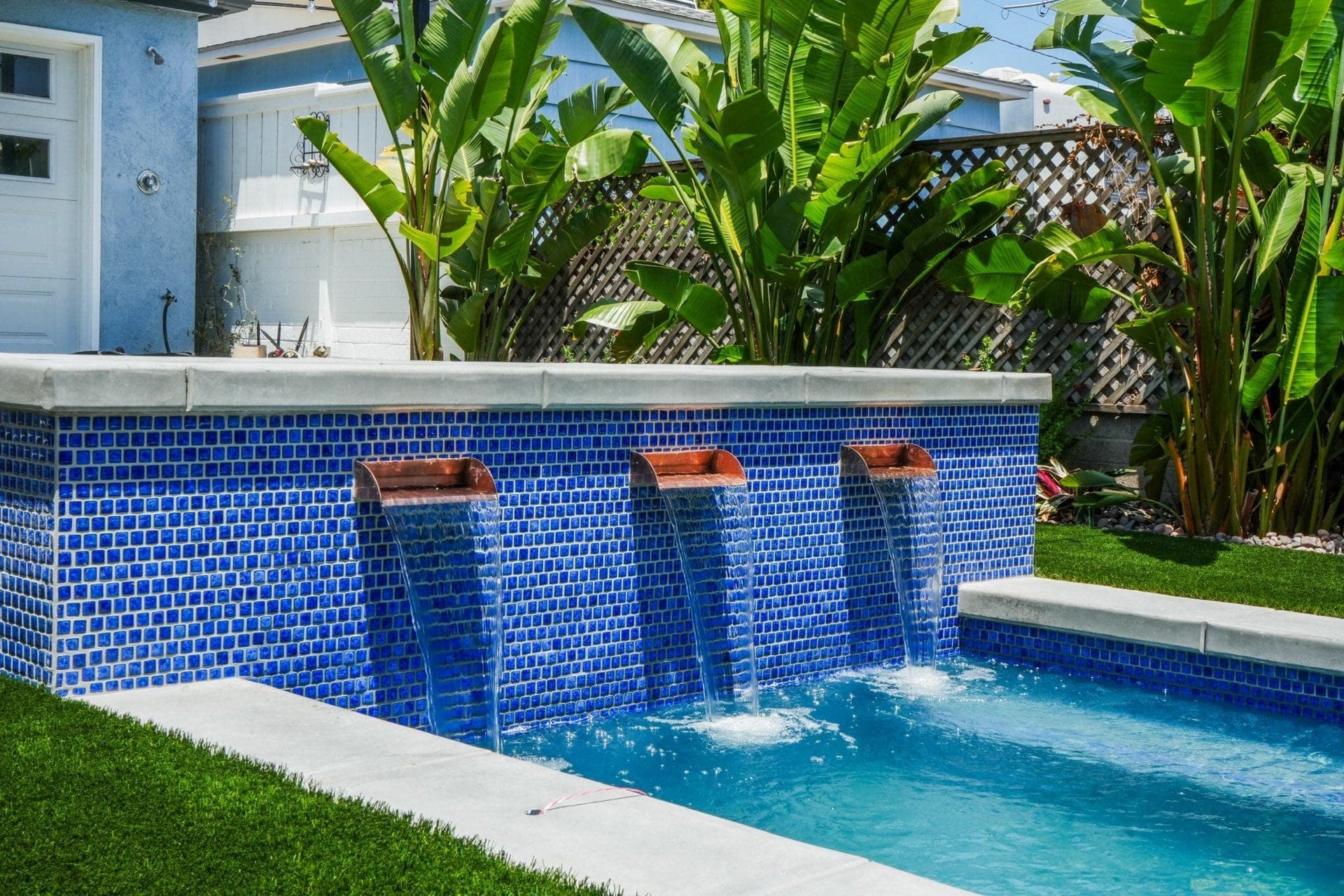 Modern Yardz backyard pool and landscape design in San Diego with blue mosaic tile water features