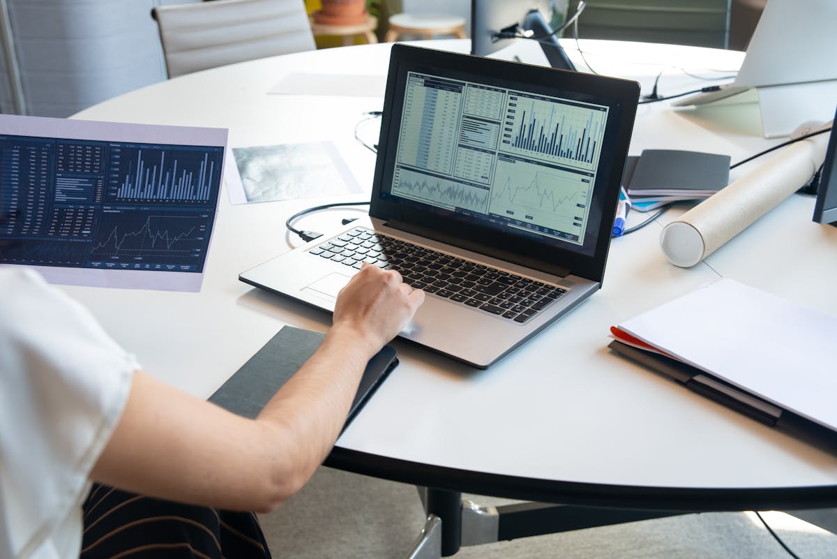 Marketing analyst reviewing performance dashboards on a laptop